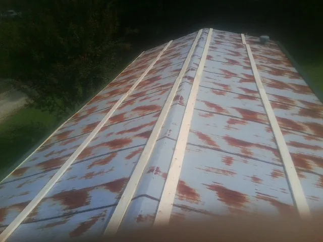 Rusted metal roof panels with new wood purlins before replacement — Storm Damage Roof Repair in Swaledale by Roofing Brothers