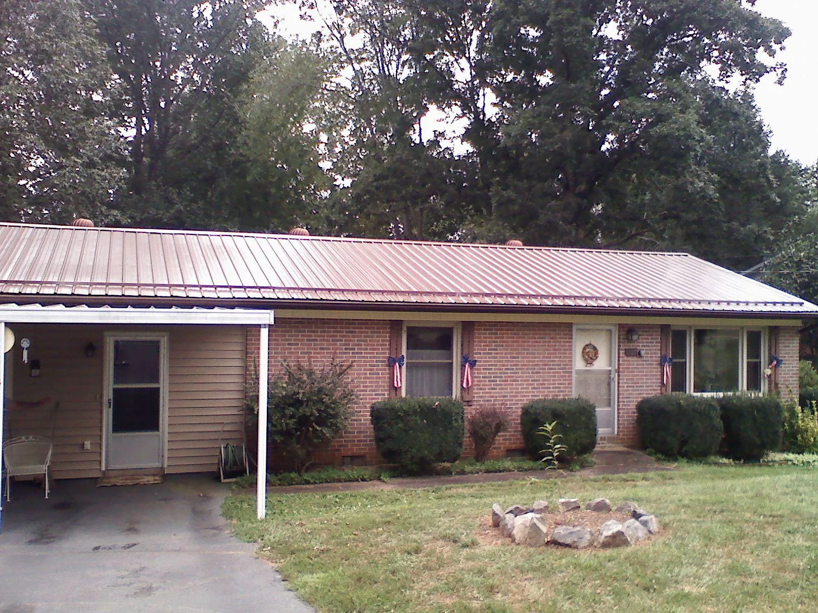 Bronze metal roof and carport on a brick ranch home — Roof Repair work by our crew in Swaledale